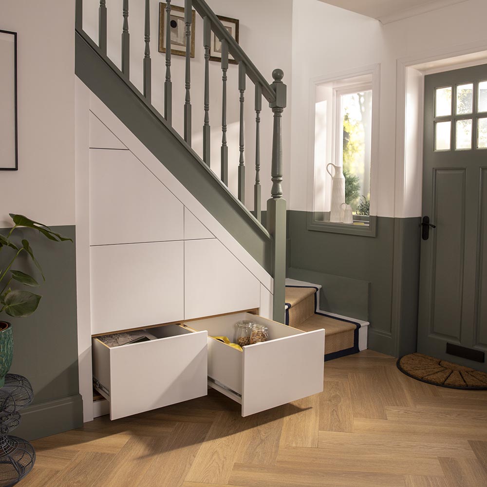 White understairs storage with shoes, handbags, wine and books